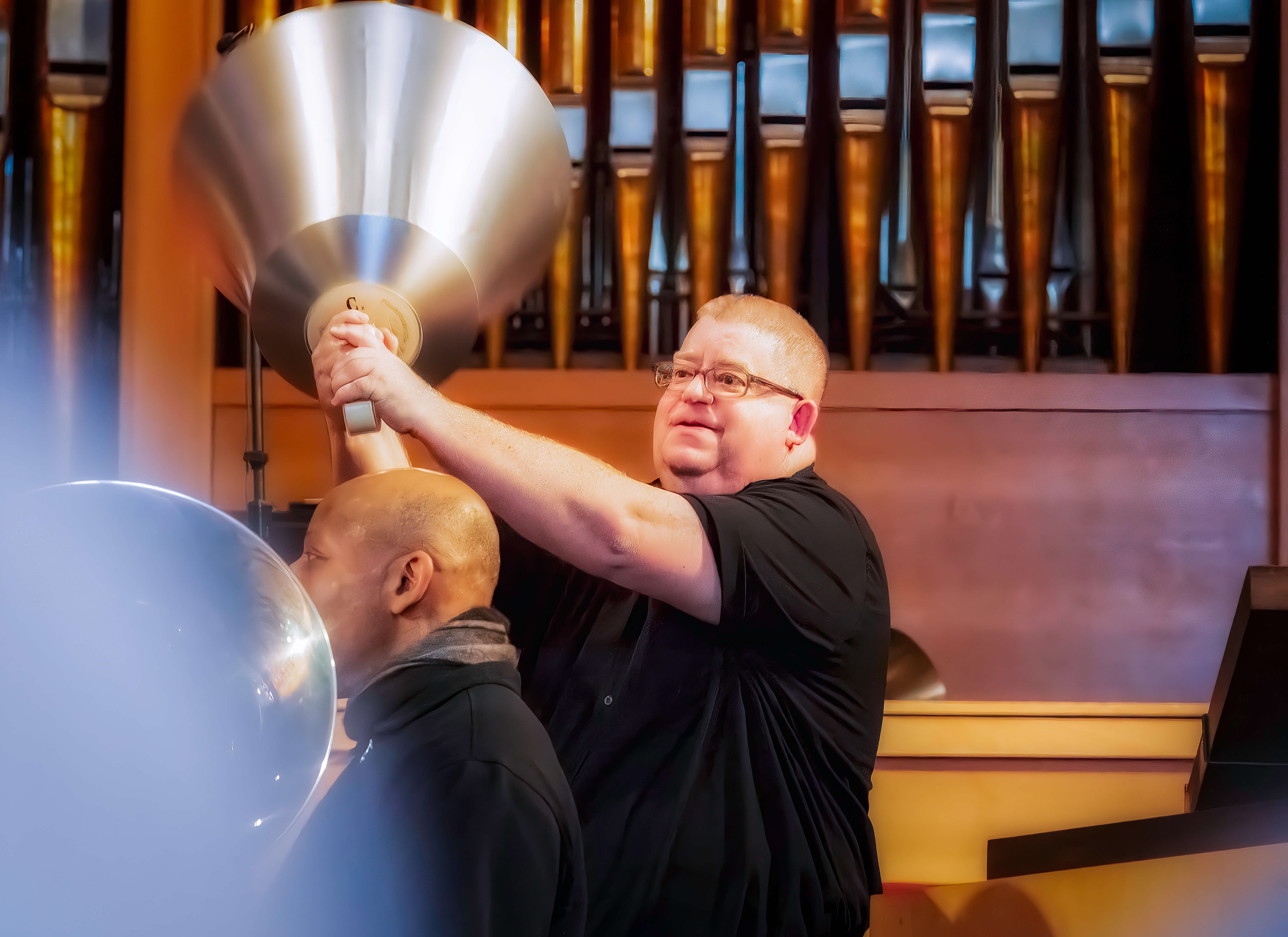 A man ringing a large handbell.