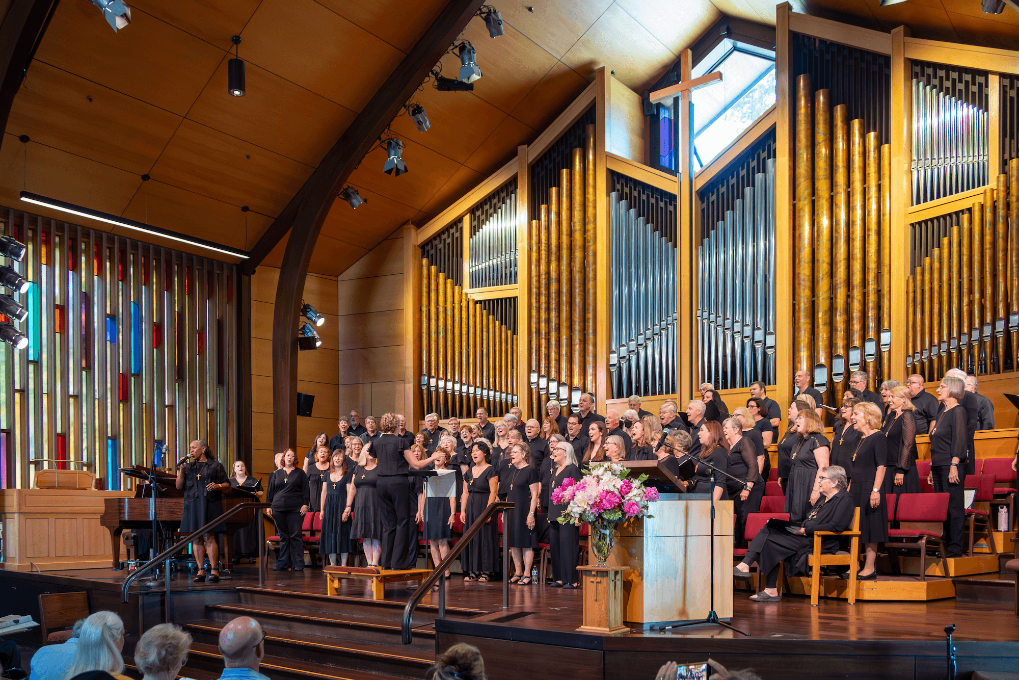 Choir members wearing black and singing.